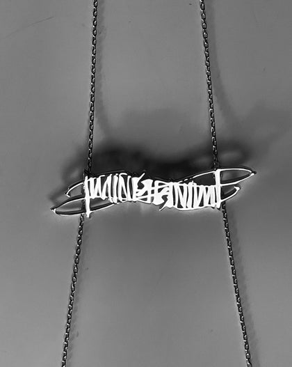 Ambie Stapleton x Brenda Hashtag Custom Timing necklace on gray background 